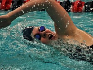 Woman swimmer takes breath during race